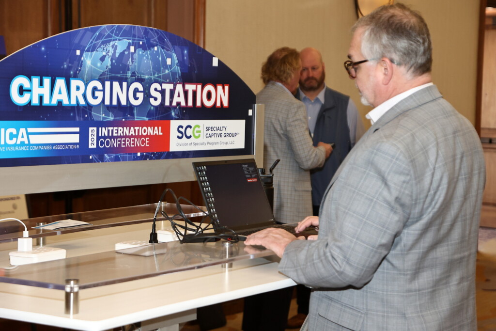 CICA 2025 International Conference attendee using the sponsored charging station