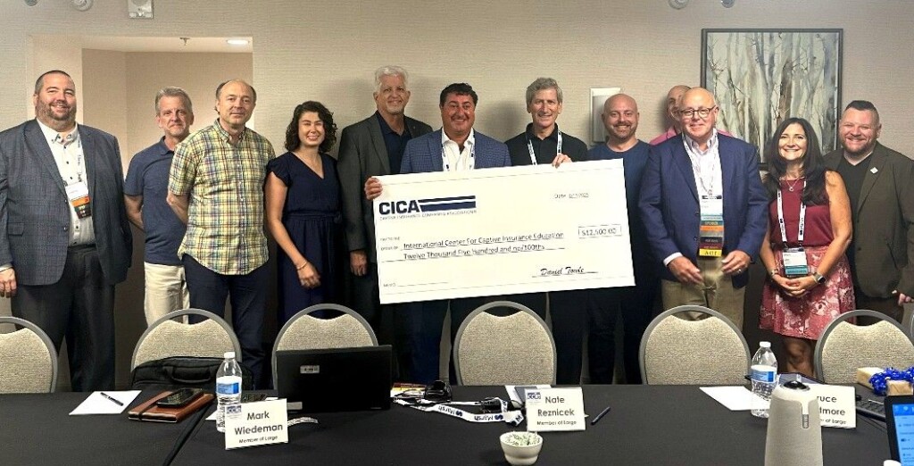 CICA President Dan Towle presents ICCIE with an annual scholarship donation.